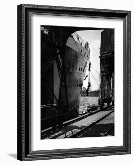 Workers Hanging from Hull of Ship in Hamburg Harbor, in the Midst of Painting It-Emil Otto Hoppé-Framed Photographic Print