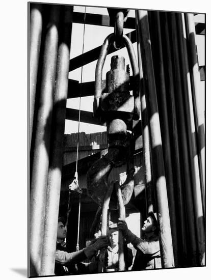 Workers Lower Pipe into Oil Well Inside Rig in a Texaco Oil Field-Margaret Bourke-White-Mounted Premium Photographic Print