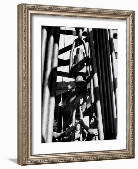 Workers Lower Pipe into Oil Well Inside Rig in a Texaco Oil Field-Margaret Bourke-White-Framed Photographic Print