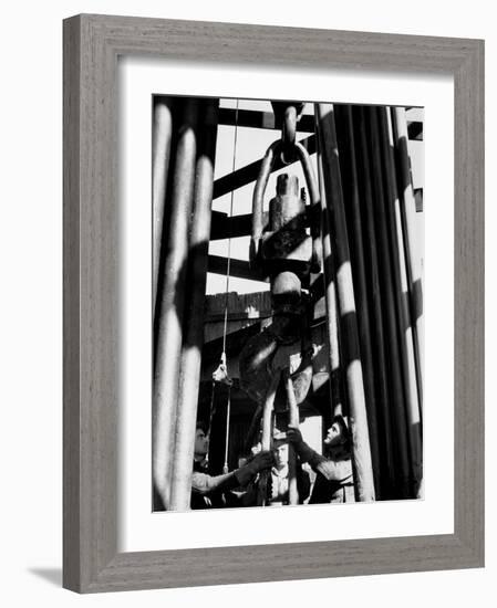 Workers Lower Pipe into Oil Well Inside Rig in a Texaco Oil Field-Margaret Bourke-White-Framed Photographic Print