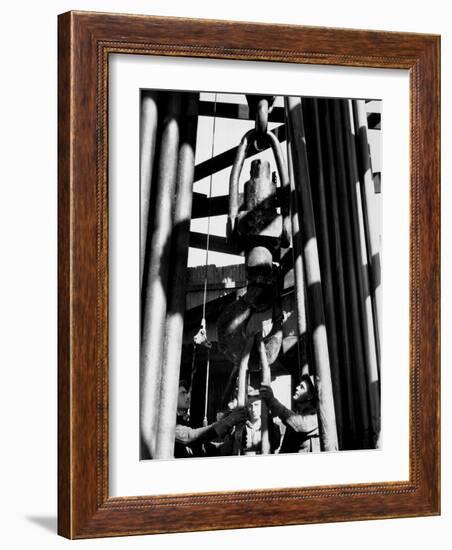 Workers Lower Pipe into Oil Well Inside Rig in a Texaco Oil Field-Margaret Bourke-White-Framed Photographic Print