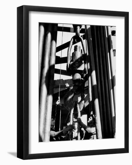 Workers Lower Pipe into Oil Well Inside Rig in a Texaco Oil Field-Margaret Bourke-White-Framed Photographic Print