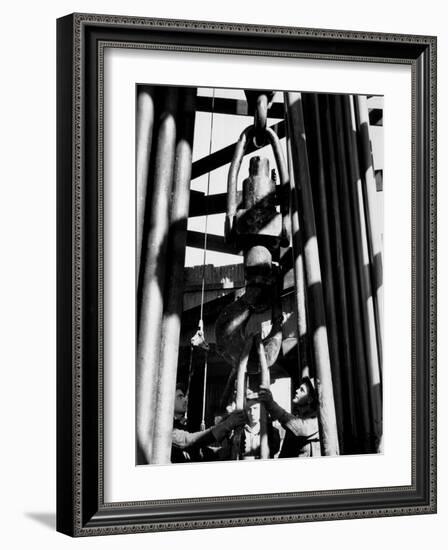 Workers Lower Pipe into Oil Well Inside Rig in a Texaco Oil Field-Margaret Bourke-White-Framed Photographic Print