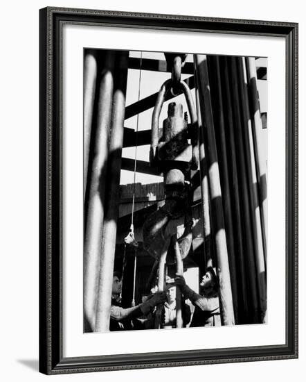 Workers Lower Pipe into Oil Well Inside Rig in a Texaco Oil Field-Margaret Bourke-White-Framed Photographic Print