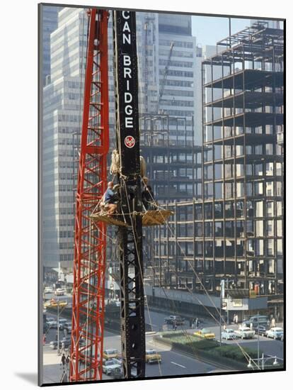 Workers Service Crane Across Street from National Bank Building under Construction on Park Ave-Dmitri Kessel-Mounted Photographic Print