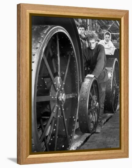 Workers Standing Amidst Large Metal Wheel Frames on Tractorstroi Tractor Factory Assembly Line-Margaret Bourke-White-Framed Premier Image Canvas