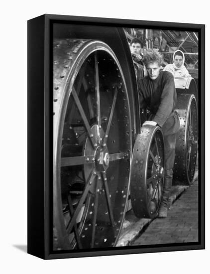 Workers Standing Amidst Large Metal Wheel Frames on Tractorstroi Tractor Factory Assembly Line-Margaret Bourke-White-Framed Premier Image Canvas