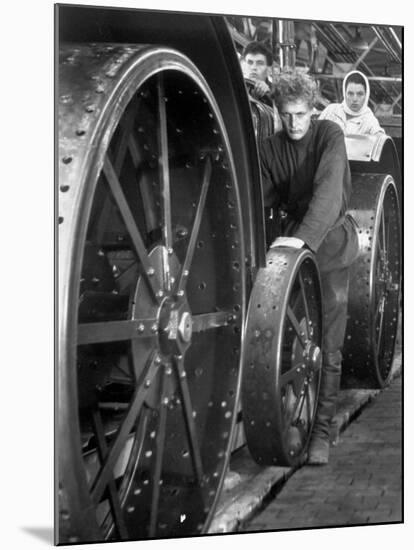 Workers Standing Amidst Large Metal Wheel Frames on Tractorstroi Tractor Factory Assembly Line-Margaret Bourke-White-Mounted Premium Photographic Print