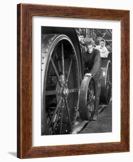 Workers Standing Amidst Large Metal Wheel Frames on Tractorstroi Tractor Factory Assembly Line-Margaret Bourke-White-Framed Photographic Print