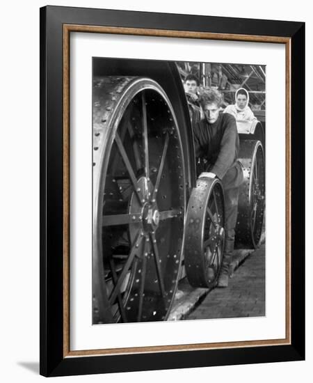 Workers Standing Amidst Large Metal Wheel Frames on Tractorstroi Tractor Factory Assembly Line-Margaret Bourke-White-Framed Photographic Print