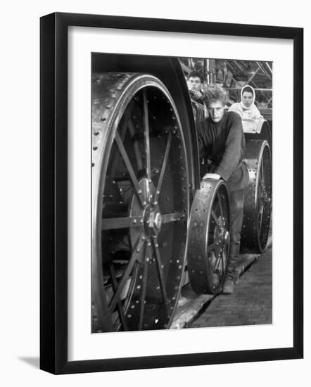 Workers Standing Amidst Large Metal Wheel Frames on Tractorstroi Tractor Factory Assembly Line-Margaret Bourke-White-Framed Photographic Print