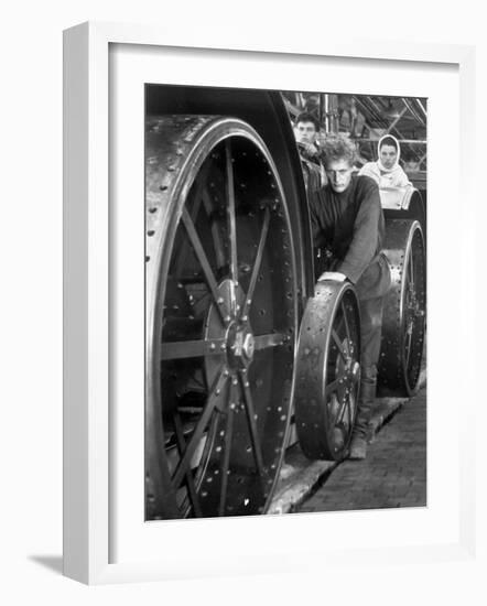 Workers Standing Amidst Large Metal Wheel Frames on Tractorstroi Tractor Factory Assembly Line-Margaret Bourke-White-Framed Photographic Print