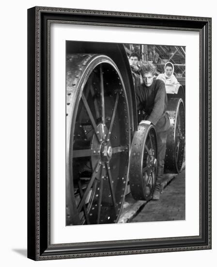 Workers Standing Amidst Large Metal Wheel Frames on Tractorstroi Tractor Factory Assembly Line-Margaret Bourke-White-Framed Photographic Print