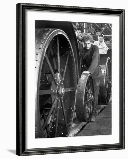 Workers Standing Amidst Large Metal Wheel Frames on Tractorstroi Tractor Factory Assembly Line-Margaret Bourke-White-Framed Photographic Print