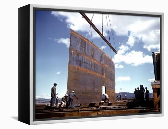 Workers Watching as Steel Beam is Raised High Above During Sub Assembling of Ship at Shipyard-Hansel Mieth-Framed Premier Image Canvas