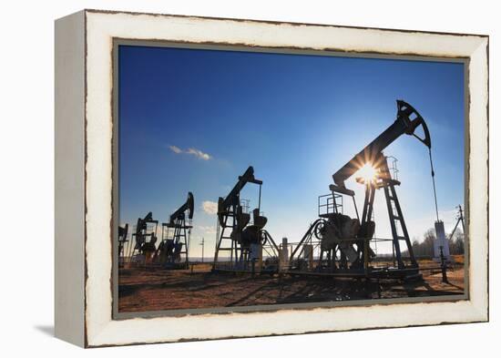 Working Oil Pumps Silhouette against Sun-Kokhanchikov-Framed Premier Image Canvas