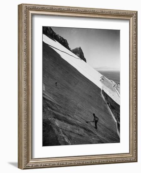 Workman Cleaning Concrete Which Catches Rain Water on Gibraltar-Ralph Crane-Framed Photographic Print