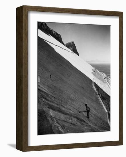 Workman Cleaning Concrete Which Catches Rain Water on Gibraltar-Ralph Crane-Framed Photographic Print