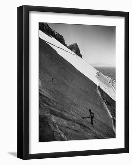 Workman Cleaning Concrete Which Catches Rain Water on Gibraltar-Ralph Crane-Framed Photographic Print