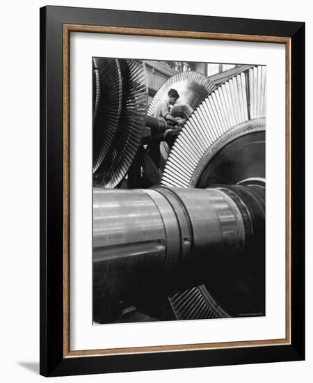 Workman on Large Wheel That Looks Like Fan, at General Electric Laboratory-Alfred Eisenstaedt-Framed Photographic Print