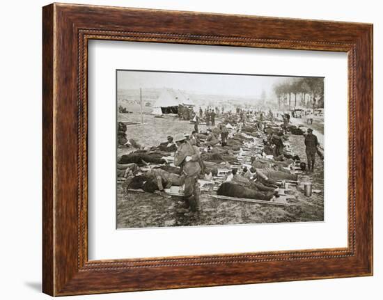 Wounded men waiting to be taken away to a clearing station, France, World War I, 1916-Unknown-Framed Photographic Print