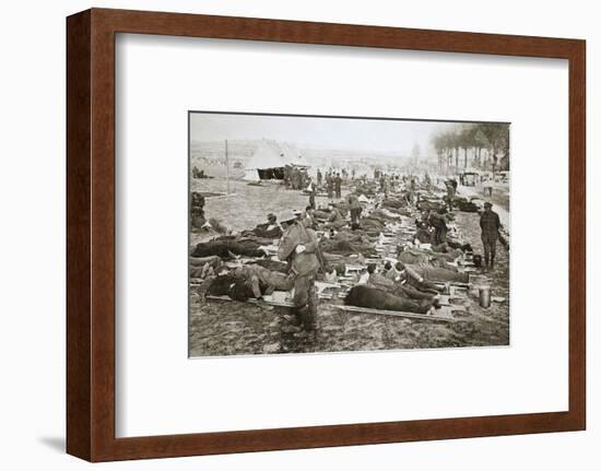 Wounded men waiting to be taken away to a clearing station, France, World War I, 1916-Unknown-Framed Photographic Print