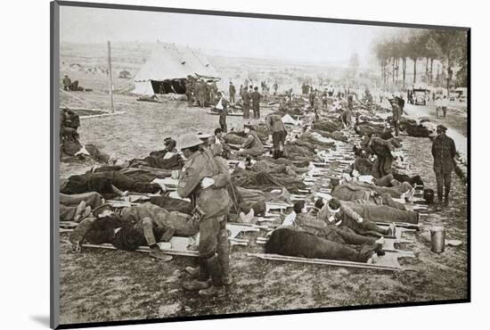 Wounded men waiting to be taken away to a clearing station, France, World War I, 1916-Unknown-Mounted Photographic Print