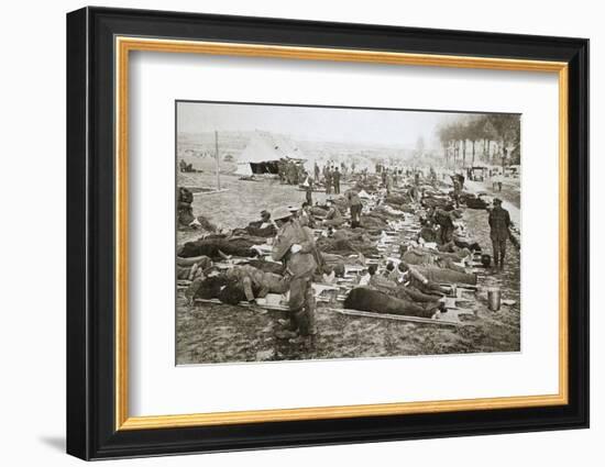 Wounded men waiting to be taken away to a clearing station, France, World War I, 1916-Unknown-Framed Photographic Print