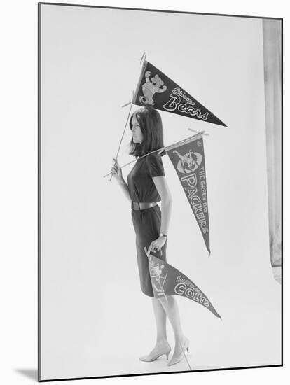 Writer Gloria Steinem Carrying Pennants for Professional Football Teams-Yale Joel-Mounted Premium Photographic Print