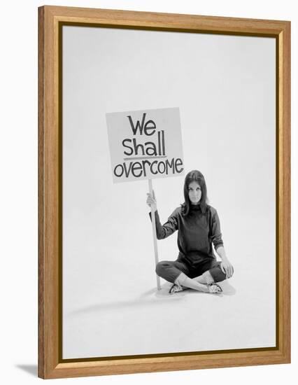 Writer Gloria Steinem Sitting on Floor with Sign "We Shall Overcome" Regarding Pop Culture-Yale Joel-Framed Premier Image Canvas