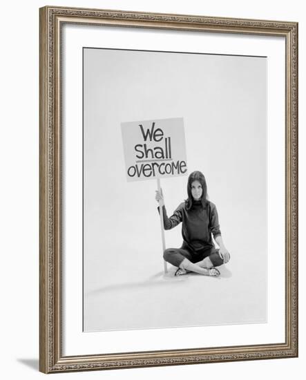 Writer Gloria Steinem Sitting on Floor with Sign "We Shall Overcome" Regarding Pop Culture-Yale Joel-Framed Premium Photographic Print