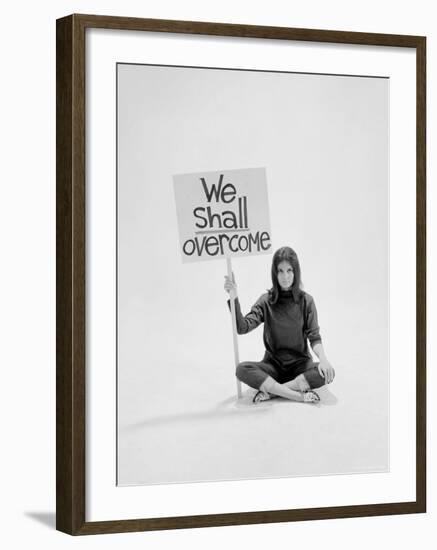 Writer Gloria Steinem Sitting on Floor with Sign "We Shall Overcome" Regarding Pop Culture-Yale Joel-Framed Premium Photographic Print