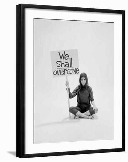 Writer Gloria Steinem Sitting on Floor with Sign "We Shall Overcome" Regarding Pop Culture-Yale Joel-Framed Premium Photographic Print