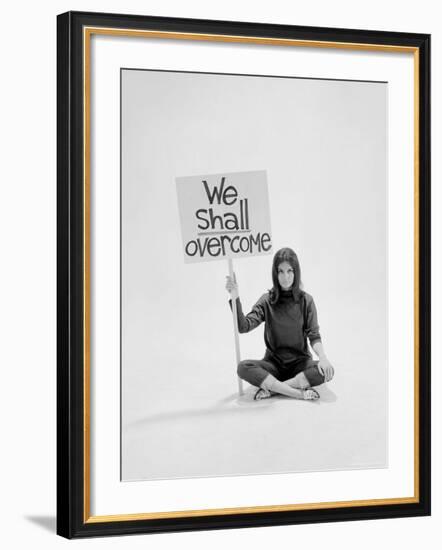 Writer Gloria Steinem Sitting on Floor with Sign "We Shall Overcome" Regarding Pop Culture-Yale Joel-Framed Premium Photographic Print