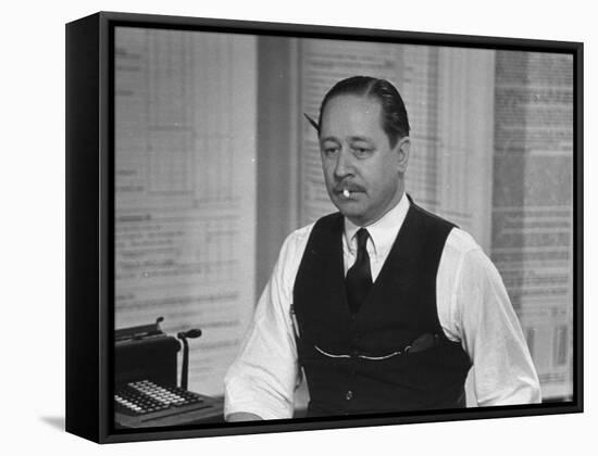 Writer Robert Benchley, Sitting at His Desk with a Small Wade of Paper in His Mouth-Bernard Hoffman-Framed Premier Image Canvas