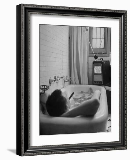 Writer Russell Finch Taking Portable Television Set to Bathroom During His Bath-George Skadding-Framed Photographic Print