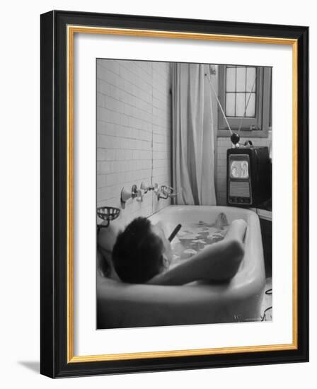 Writer Russell Finch Taking Portable Television Set to Bathroom During His Bath-George Skadding-Framed Photographic Print