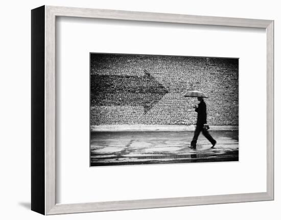 Wrong Way. A Man with Umbrella. Conceptual Image, Film Grain Added-Drop of Light-Framed Photographic Print