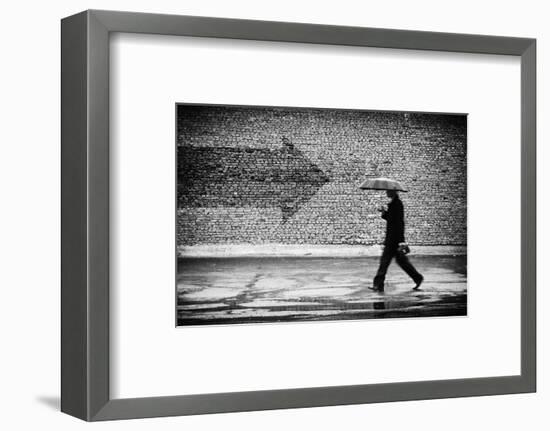 Wrong Way. A Man with Umbrella. Conceptual Image, Film Grain Added-Drop of Light-Framed Photographic Print