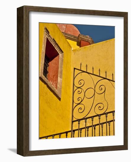 Wrought Iron Fence Against a Yellow Church Wall with Barred Window Against a Blue Sky, Mexico-Judith Zimmerman-Framed Photographic Print