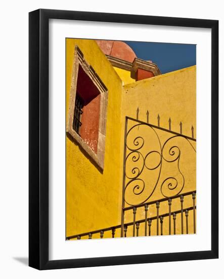 Wrought Iron Fence Against a Yellow Church Wall with Barred Window Against a Blue Sky, Mexico-Judith Zimmerman-Framed Photographic Print