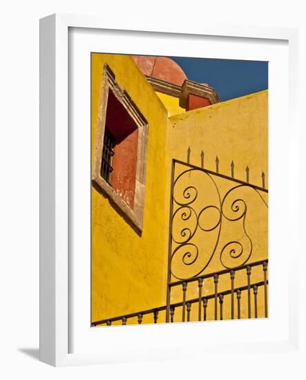 Wrought Iron Fence Against a Yellow Church Wall with Barred Window Against a Blue Sky, Mexico-Judith Zimmerman-Framed Photographic Print