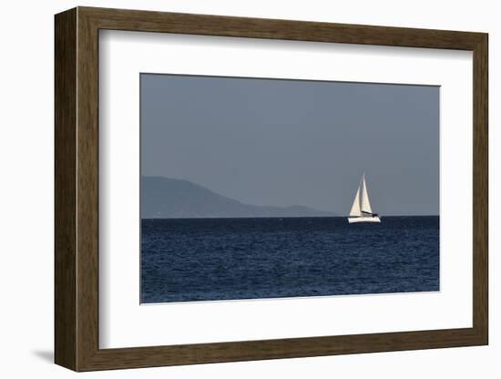 Yacht. Sailing Boat. Sailboat White Sail Boat between Blue Sky and Dark Blue Sea. an Island on Fore-PROtoys-Framed Photographic Print