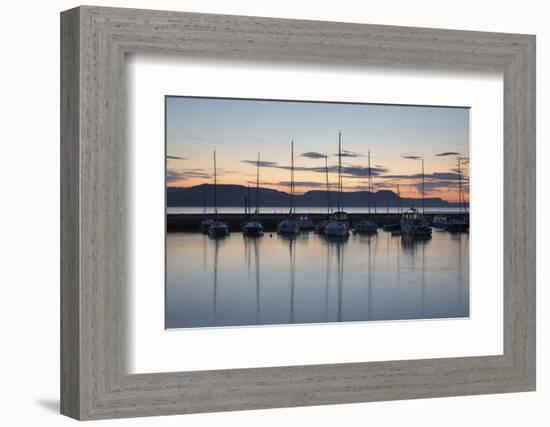 Yachts moored in The Cobb with Jurassic Coast and Golden Cap at sunrise, Lyme Regis, Dorset, Englan-Stuart Black-Framed Photographic Print