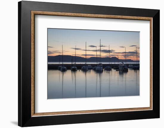 Yachts moored in The Cobb with Jurassic Coast and Golden Cap at sunrise, Lyme Regis, Dorset, Englan-Stuart Black-Framed Photographic Print