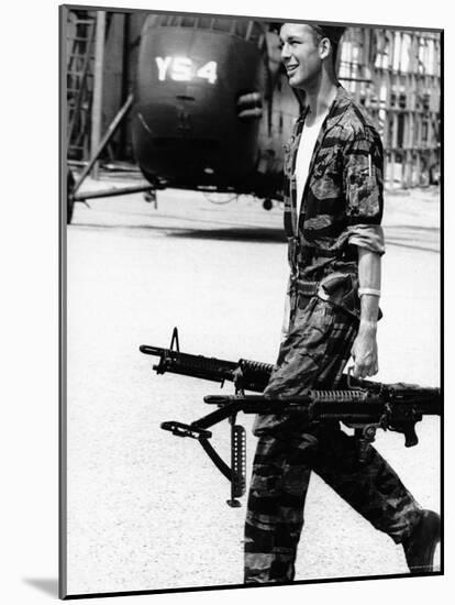 Yankee Papa 13 Helicopter Crew Chief James Farley Carrying a Pair of M-60 Machine Guns-Larry Burrows-Mounted Photographic Print