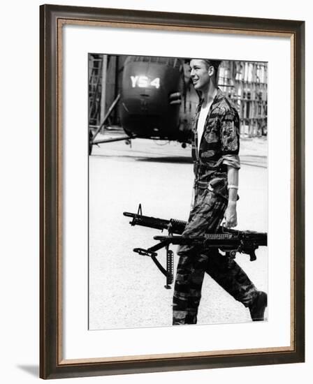 Yankee Papa 13 Helicopter Crew Chief James Farley Carrying a Pair of M-60 Machine Guns-Larry Burrows-Framed Photographic Print