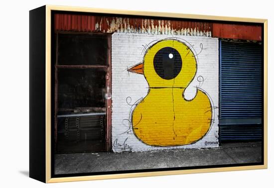 Yellow Duck on Brick Wall in Brooklyn NY-null-Framed Stretched Canvas