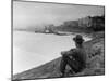 Young African American Boy Sitting on Memphis Riverbank Watching Boats on the Mississippi River-Ed Clark-Mounted Photographic Print