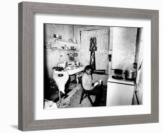 Young African American Studies by Kitchen Stove Because His Apartment Is Without Heat-null-Framed Photo